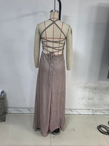 Detail of rose gold sequin evening dress featuring backless crisscross straps and sparkle fabric