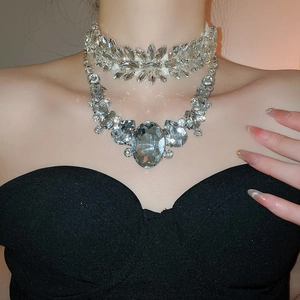 Close-up of elegant silver teardrop crystal necklace set worn by a fashion model