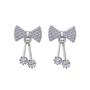 Macro detail of silver bow cherry drop earrings with sparkling cubic zirconia pavé