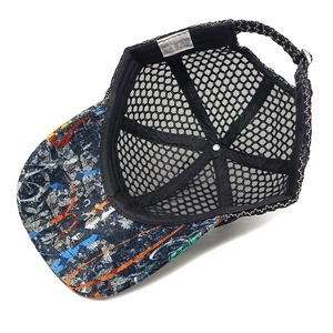Detail view of breathable black mesh interior and colorful graffiti brim of the baseball cap