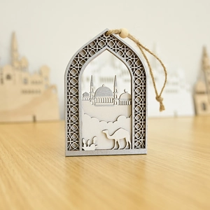 Hollow wood Islamic ornament featuring mosque and camel designs with hanging rope