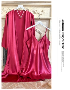 Detail of luxury burgundy satin robe and slip dress set with elegant silk texture