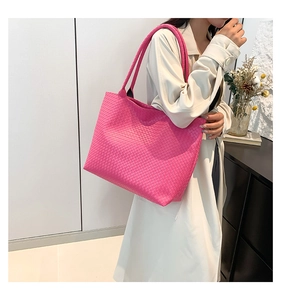 Close-up of vibrant pink woven leather texture and large tote bag craftsmanship