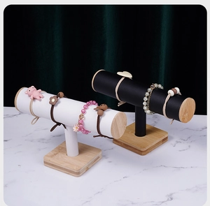 Detail of T-bar jewelry display stands with black and white leather on wood bases