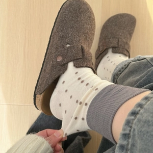 Polka dot crew socks for women styled with vintage brown felt clogs on wood floor