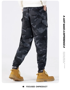 Detail of men's camouflage cargo pants showing side pockets and tapered cuffs