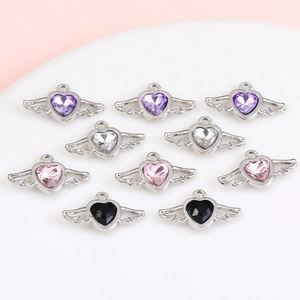 Detailed close-up of heart wing charms with colorful crystals for DIY jewelry making