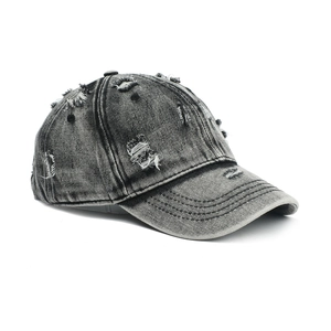 Macro detail of distressed vintage baseball cap with washed denim holes and frayed edges