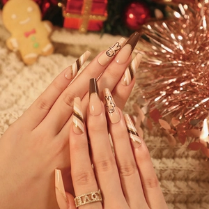 Brown French coffin nails with festive gingerbread man and striped glitter patterns