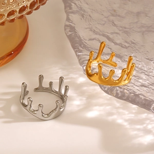 Modern 18K gold and silver molten lava style irregular open rings on glass surface