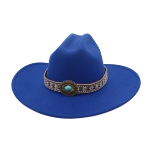 Detail of navy blue felt cowboy hat with ethnic embroidered band and turquoise stud