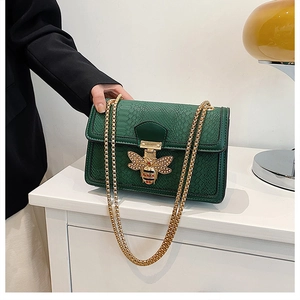 Green snakeskin embossed small square bag with golden bee clasp and chain straps