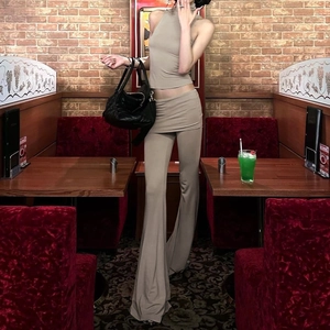 Detail view of khaki sleeveless halter top and matching flared pants set on female model