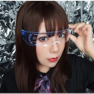 Close-up of LED glowing glasses with blue futuristic geometric patterns on clear lenses