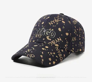 Detailed side view of navy blue baseball cap with gold splatter and NY&GD embroidery