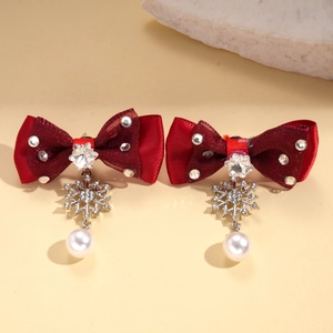 Detail of red bow earring with rhinestone snowflake and round pearl drop pendant