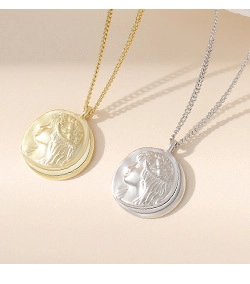 Detailed view of vintage gold and silver coin pendants with elegant female profile relief