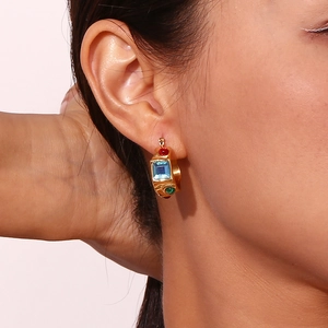 Close-up of 18K gold plated lava earrings featuring square blue gems and colorful stones
