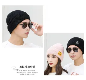 Detail of ribbed knit beanie with Moment of Ambitions fabric label for men and women