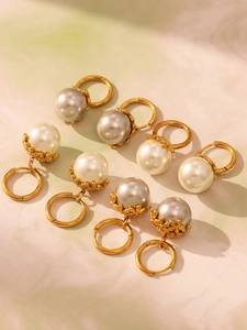 Detail of 18k gold plated stainless steel pearl drop earrings with elegant shell beads