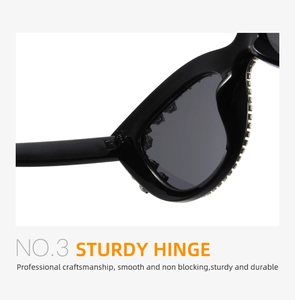 Detail showing a sturdy hinge on black cat eye sunglasses with silver rhinestone inlay