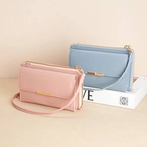 Minimalist women's crossbody wallet bag in pastel pink and blue with gold accents