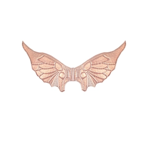 Close-up of rose gold decorative wings with detailed feather texture and metallic finish