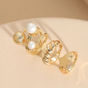 Detailed view of three-piece 14K gold plated ring set with pearl and star motifs