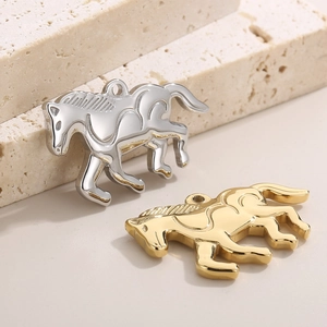Polished stainless steel horse pendants in gold and silver finish on stone background
