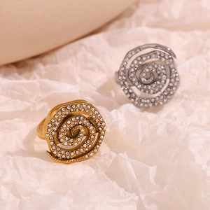 Detailed macro view of spiral 18K gold and silver rings with pave set rhinestones