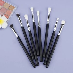 8-piece professional eye shadow brush set with matte black handles on purple background