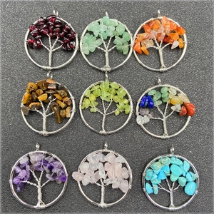 Macro shot of nine different natural crystal tree of life pendants in silver wire wrap