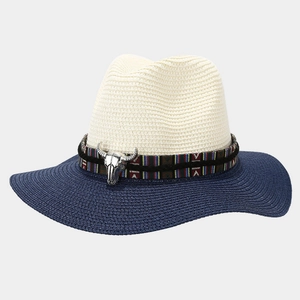 Close-up of ethnic striped band and silver bull head ornament on woven straw panama hat