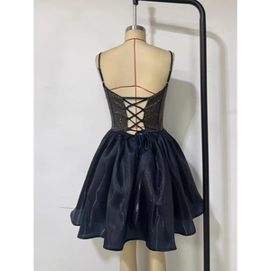 Detail of cross lace-up open back design on a dark navy embellished party dress
