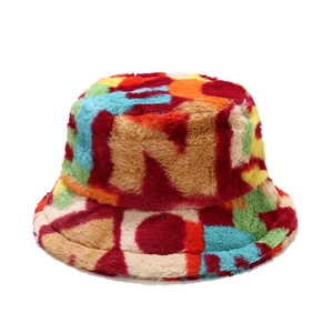 Colorful plush faux fur bucket hat with vibrant geometric patchwork for winter warmth