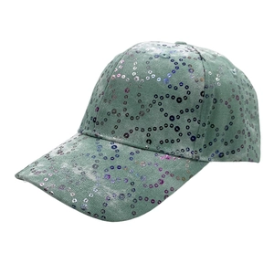 Close-up of a sage green baseball cap featuring sparkling sequin heart and wave patterns