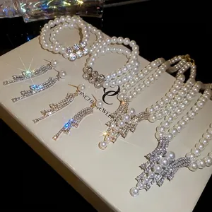 Elegant vintage jewelry set with pearl necklaces, bracelets and rhinestone earrings