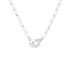 Detailed view of silver handcuff pendant on a trendy paperclip chain necklace