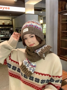 Detail view of Fair Isle knit winter set featuring Nordic snowflake patterns and hearts