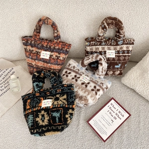 Collection of plush tote bags in various patterns displayed on a cozy sofa