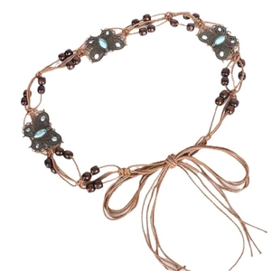 Bohemian brown woven waist chain with bronze butterflies and blue gemstones on white background