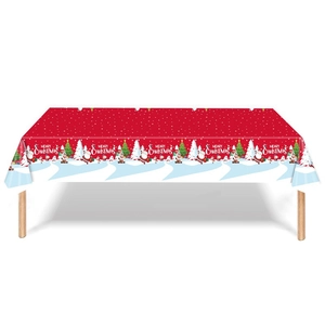 Detail of red Christmas tablecloth featuring Santa, snowmen, and white polka dots pattern