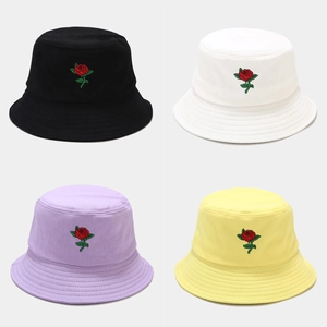 Detail of rose embroidery and stitch patterns on colorful cotton bucket hats