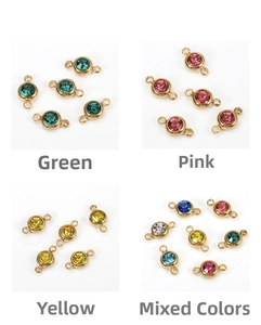 Detailed view of DIY gold birthstone charms with crystals in green, pink and yellow