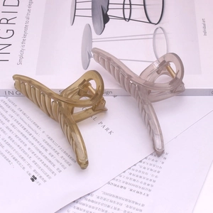 Close-up of translucent amber and purple hair claw clips with ribbed texture details