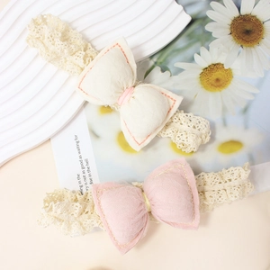 Handmade elastic lace baby headbands with padded fabric bows in beige and pink colors