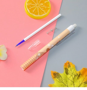 Disassembled view showing orange pen barrel, blue ink refill, and internal spring components