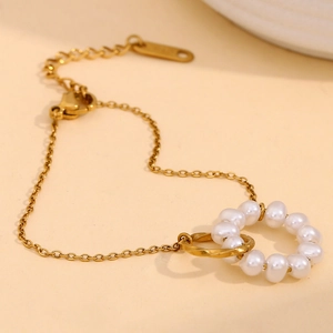 Detail view of 18K gold-plated double-link bracelet with pearl and twisted rope design