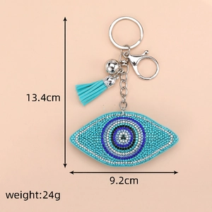 Close-up of evil eye bag charm with blue rhinestones and measurements 13.4cm by 9.2cm