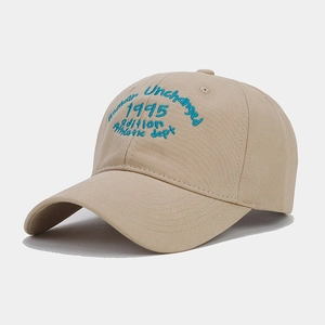 Macro detail of khaki cotton baseball cap with blue retro collegiate embroidery